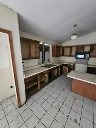 a view of kitchen with stainless steel appliances a sink and cabinets