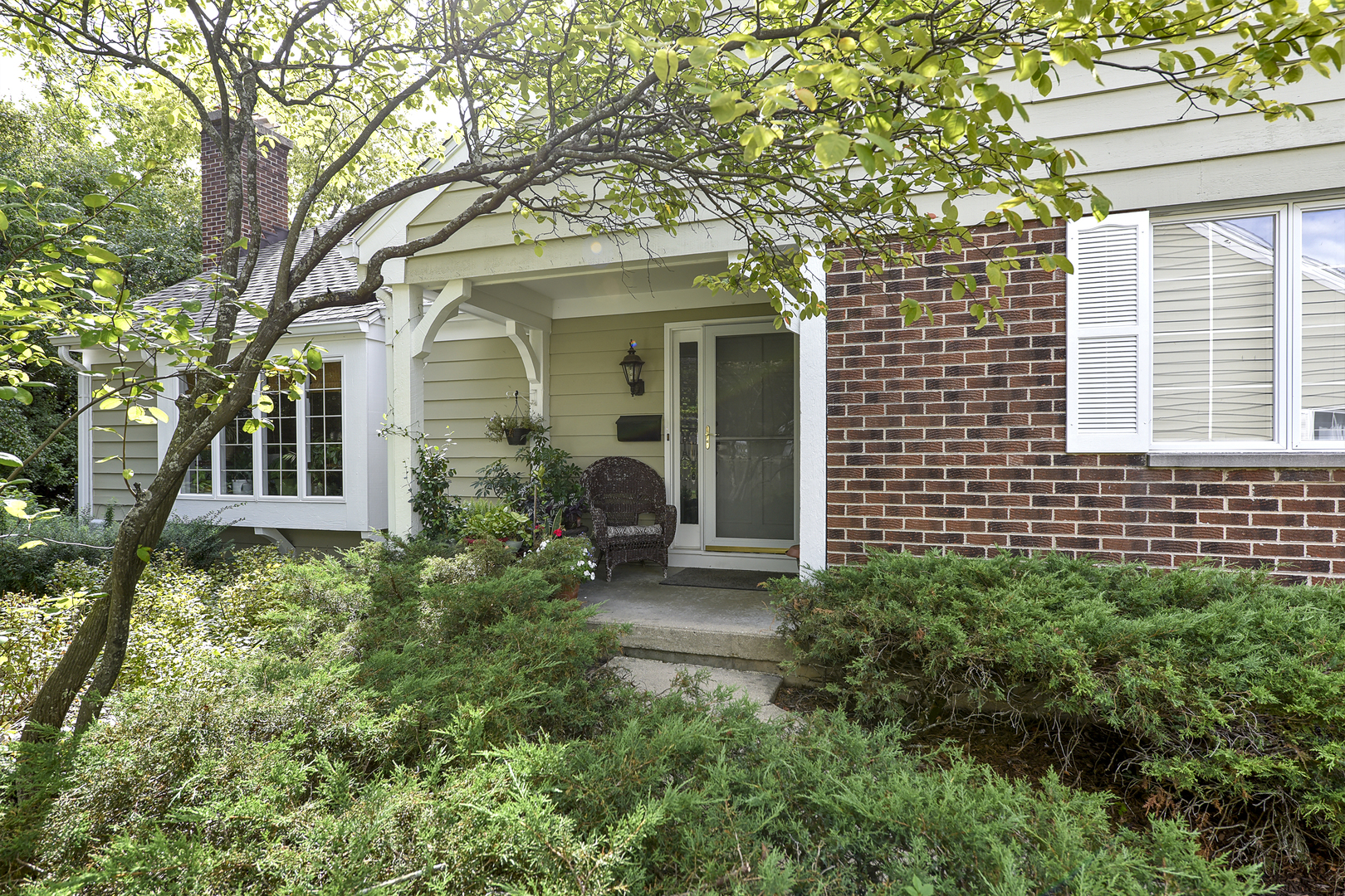 front view of a house with potted plants