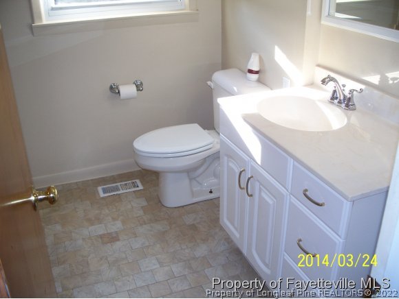 3636 Drayton Road Fayetteville, NC 28303 - Photo 14 of 25 a bathroom with a sink a toilet and a mirror
