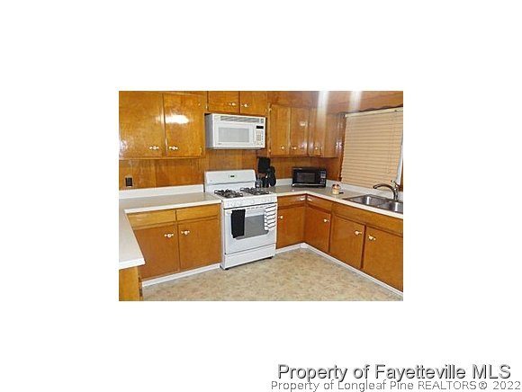3636 Drayton Road Fayetteville, NC 28303 - Photo 24 of 25 a kitchen with a stove and a microwave