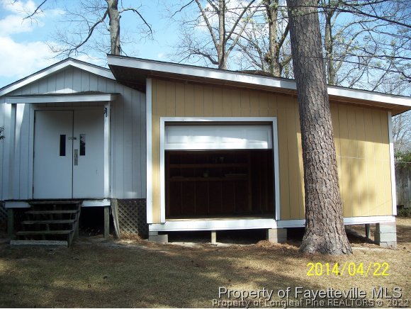 3636 Drayton Road Fayetteville, NC 28303 - Photo 4 of 25 a front view of a house with a garden