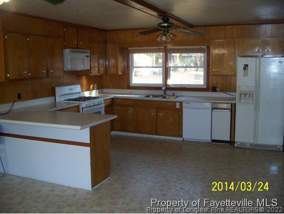 3636 Drayton Road Fayetteville, NC 28303 - Photo 9 of 25 a kitchen with stainless steel appliances granite countertop a stove a sink and a refrigerator