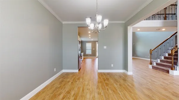 a view of a room with wooden floor and staircase