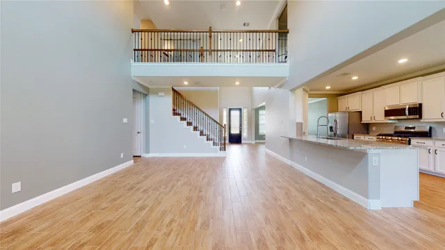 a large kitchen with stainless steel appliances granite countertop a stove and a sink