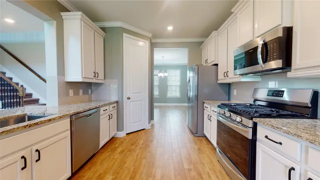 a view of an empty room with a ceiling fan and a window