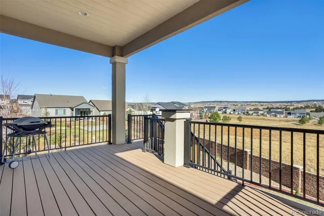 a view of balcony with wooden floor and fence