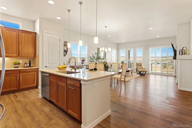 a large kitchen with lots of counter top space a sink appliances and cabinets