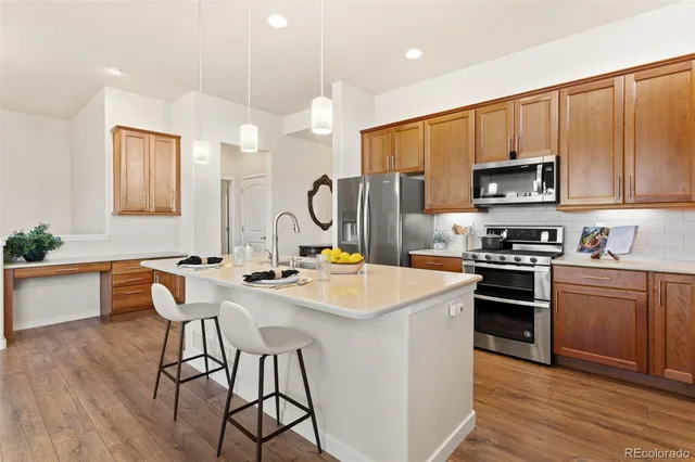 a kitchen with a stove a sink and a refrigerator