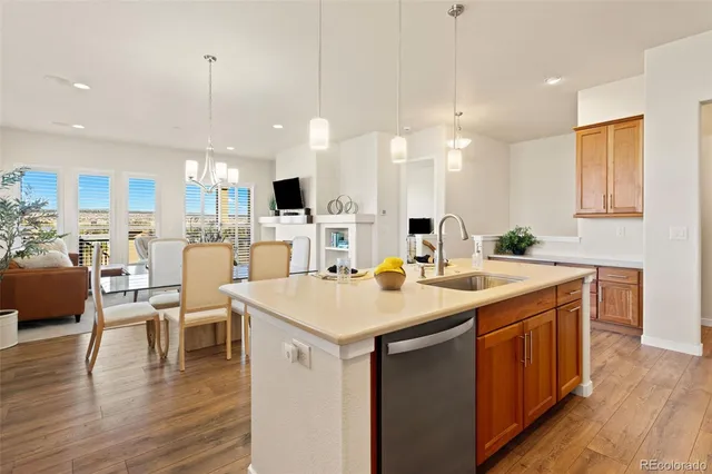 a kitchen with a table chairs stove a sink and dishwasher