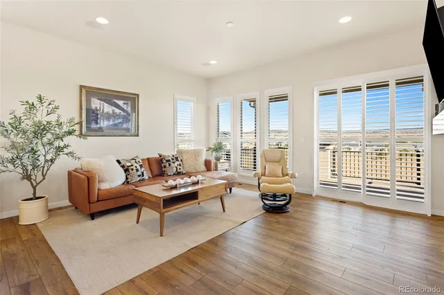 a living room with furniture and floor to ceiling window