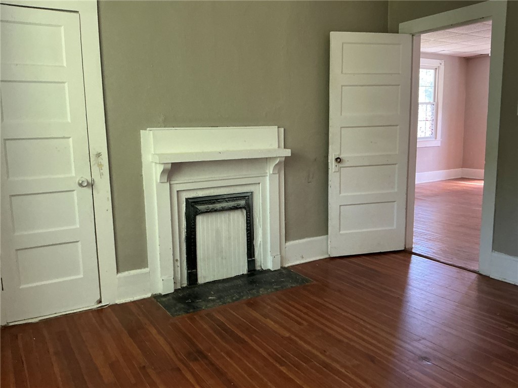 14 Ames Street Seneca, SC 29678 - Photo 8 of 15 This living area features rich hardwood floors and a classic fireplace.
