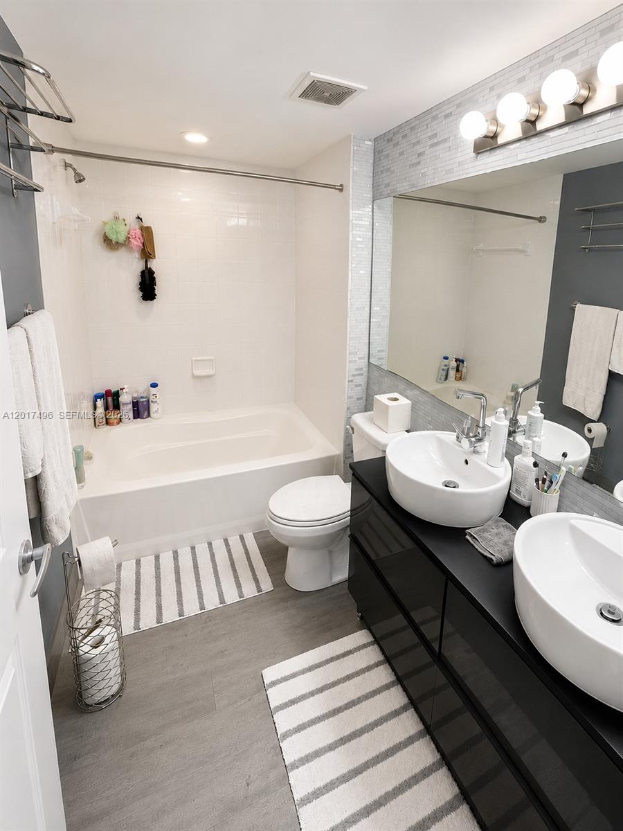 Brickell Miami, FL 33131 - Photo 15 of 19 a bathroom with a sink and mirror