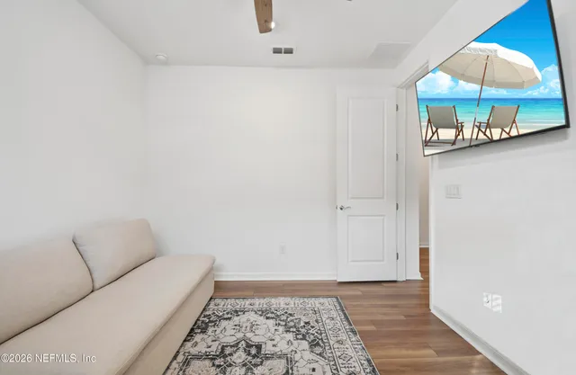 a view of a hallway with wooden floor and workspace