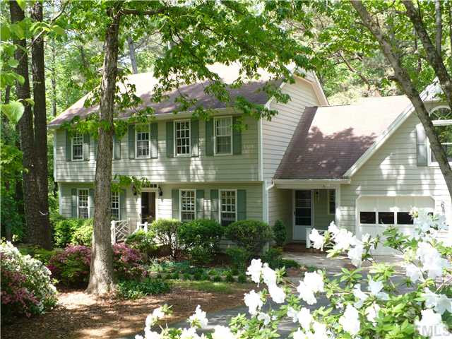 8633 Langtree Lane Raleigh, NC 27613 - Photo 1 of 12 a front view of a house with a garden and trees