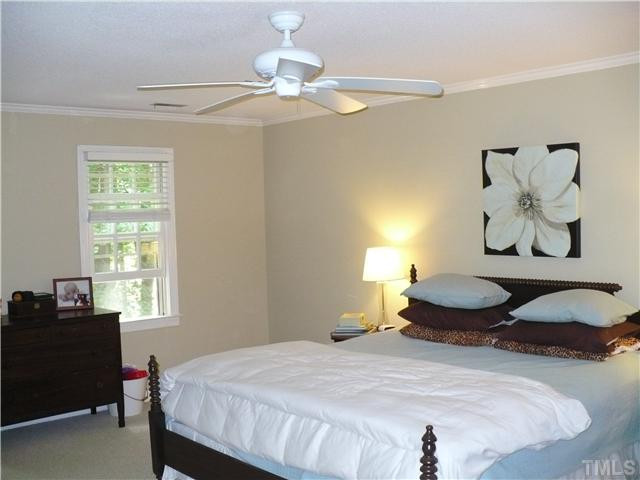 8633 Langtree Lane Raleigh, NC 27613 - Photo 6 of 12 a bedroom with a bed and window