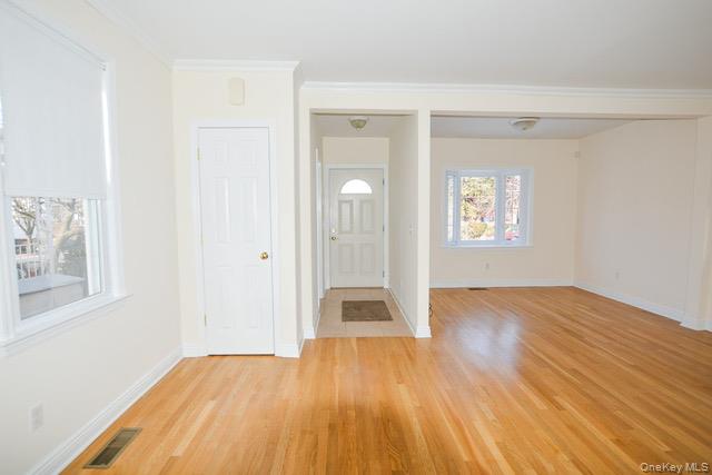 26 St Pauls Place New Rochelle, NY 10801 - Photo 2 of 16 wooden floor in an empty room with a window