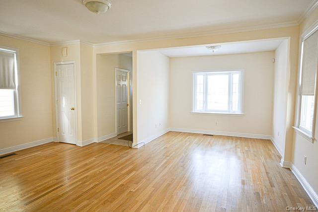 26 St Pauls Place New Rochelle, NY 10801 - Photo 3 of 16 an empty room with wooden floor and windows