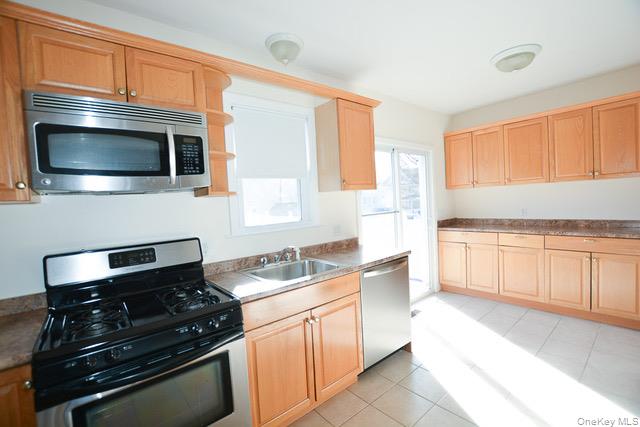 26 St Pauls Place New Rochelle, NY 10801 - Photo 5 of 16 a kitchen with granite countertop cabinets stainless steel appliances and a window