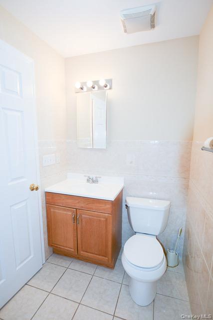 26 St Pauls Place New Rochelle, NY 10801 - Photo 7 of 16 a bathroom with a sink a toilet and mirror