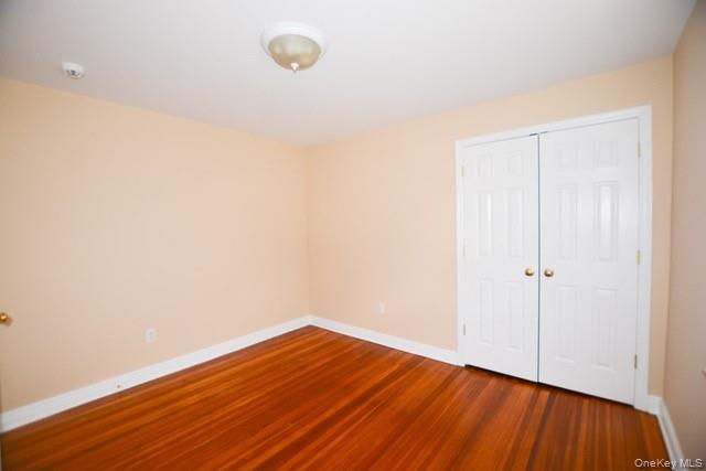 26 St Pauls Place New Rochelle, NY 10801 - Photo 9 of 16 a view of a room with wooden floor and white walls