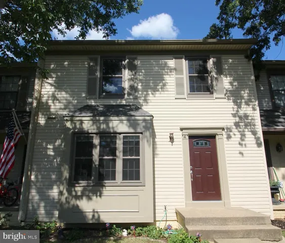 a front view of house with a garden