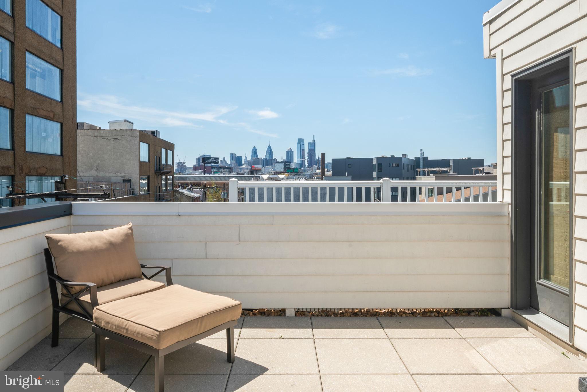 159 East Allen Street, Unit 1 Philadelphia, PA 19125 - Photo 2 of 45 a terrace with a bench and a city view