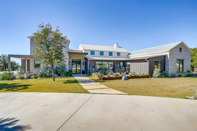a front view of house with yard and green space