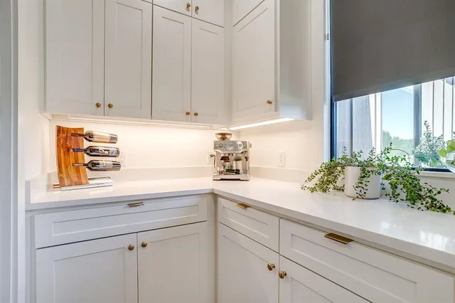 a kitchen with granite countertop a stove and cabinets