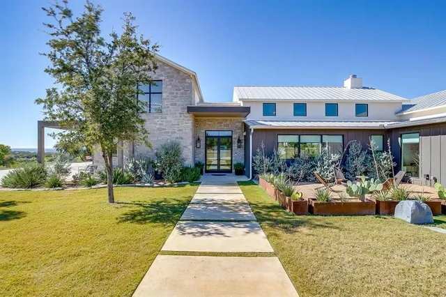 a front view of a house with swimming pool and porch