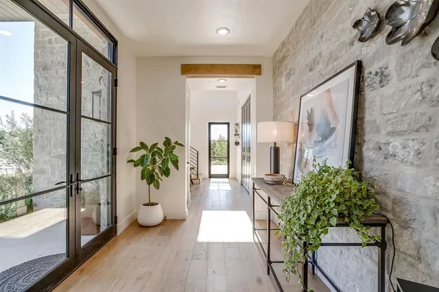 a view of hallway with wooden floor and dining room