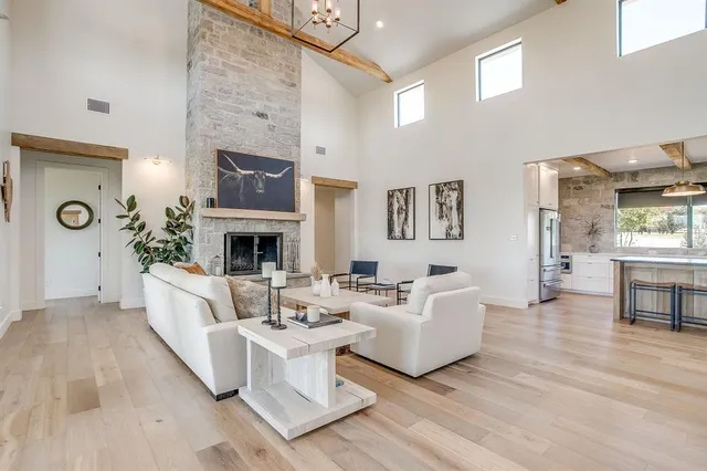 a living room with furniture a fireplace and a table