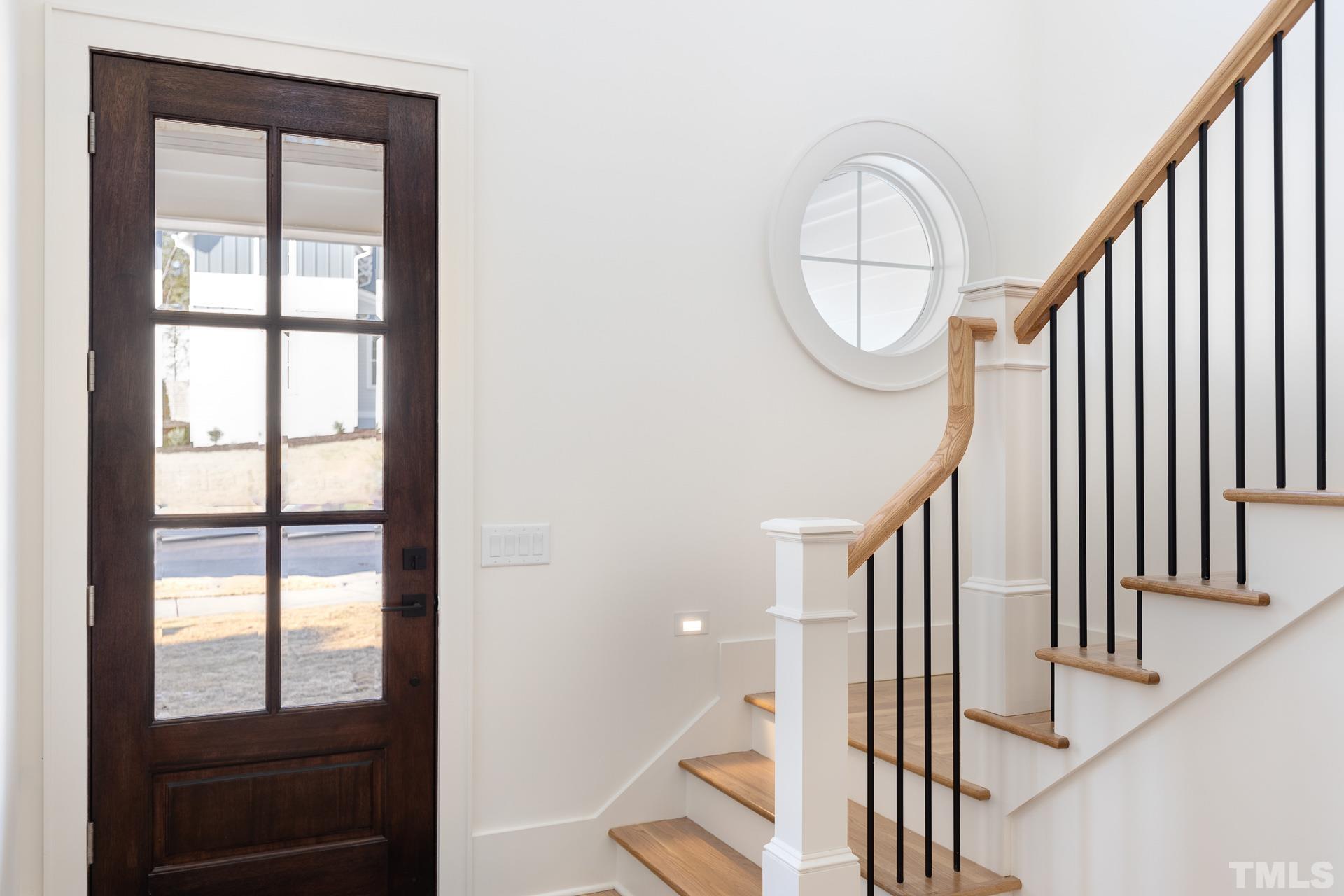 6312 Stephens Rdg Court Raleigh, NC 27615 - Photo 4 of 28 a view of staircase with railing and a window