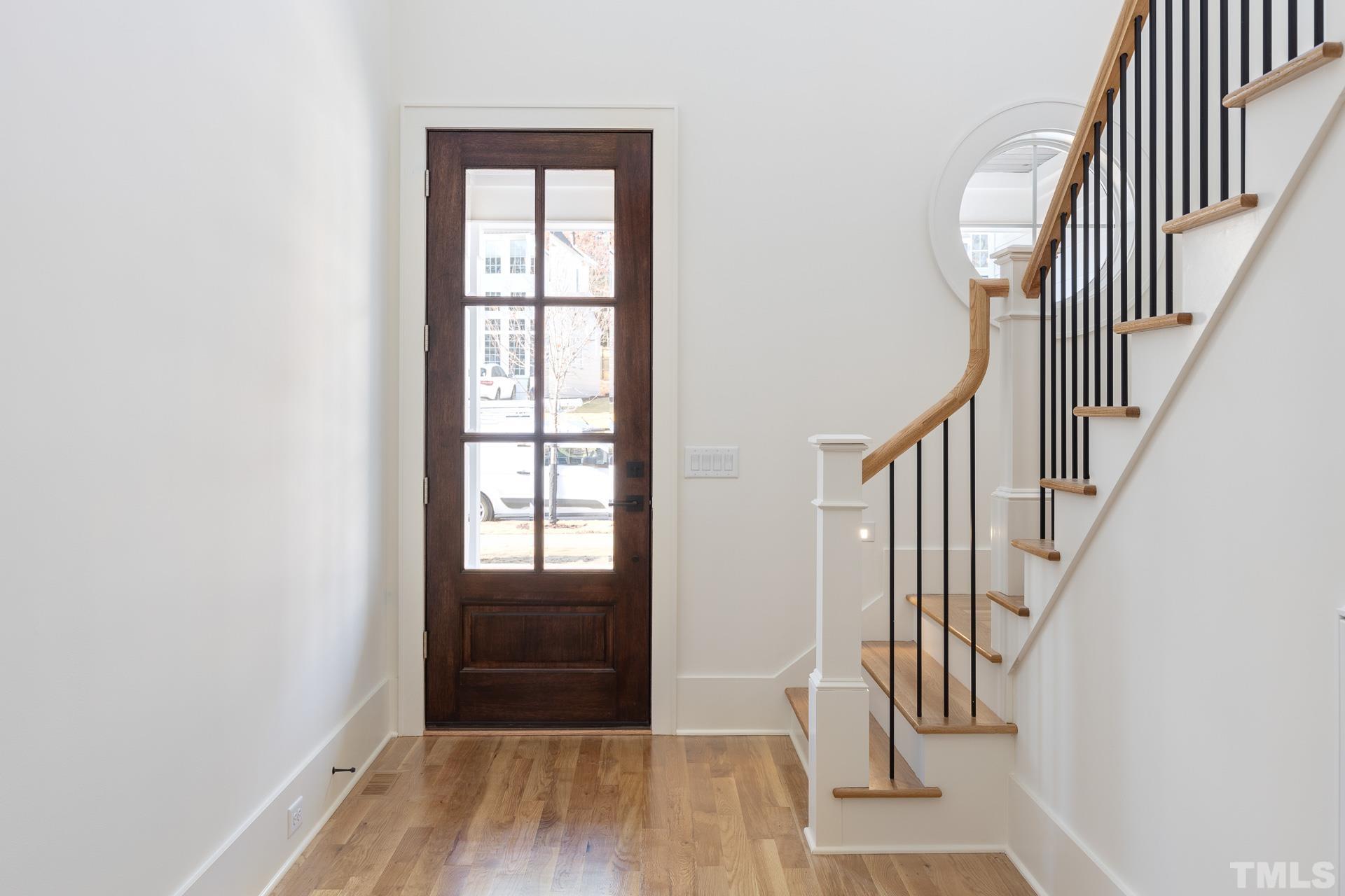 6312 Stephens Rdg Court Raleigh, NC 27615 - Photo 6 of 28 a view of a hallway with wooden floor and entryway