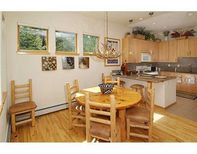 1180 North Frontage Road West, Unit 6A Vail, CO 81657 - Photo 2 of 12 a view of a dining room with furniture and wooden floor