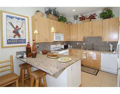 1180 North Frontage Road West, Unit 6A Vail, CO 81657 - Photo 4 of 12 a kitchen with a table chairs and cabinets