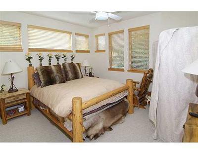 1180 North Frontage Road West, Unit 6A Vail, CO 81657 - Photo 7 of 12 a bed room with a bed and a chair