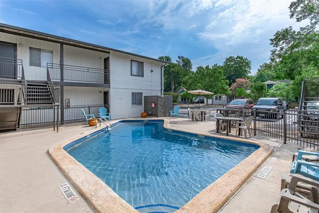 a swimming pool with outdoor seating and yard