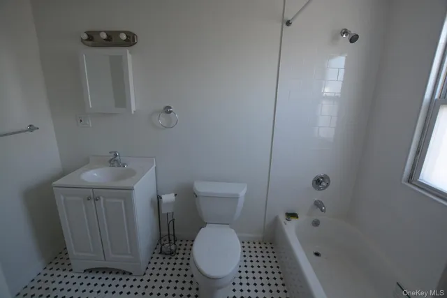 a bathroom with a toilet a sink and bathtub