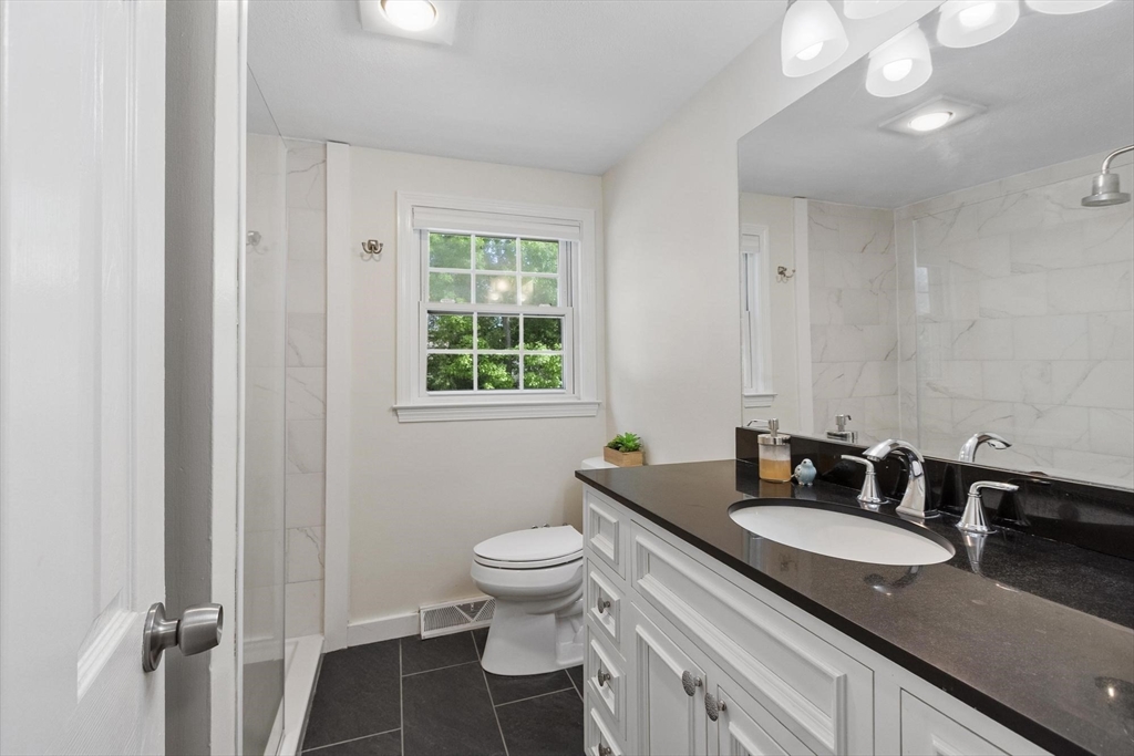6 Edith Road Hudson, MA 01749 - Photo 19 of 30 a bathroom with a granite countertop sink a toilet and a mirror