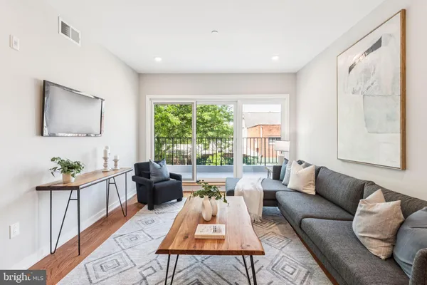 a living room with furniture and a large window