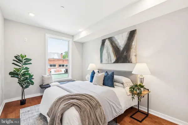 a bedroom with a bed and a potted plant