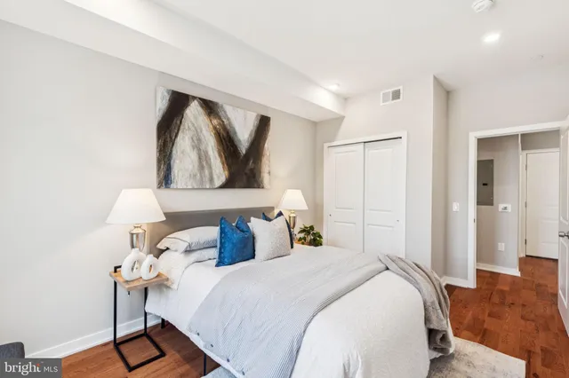 a bedroom with a bed and a painting on the wall