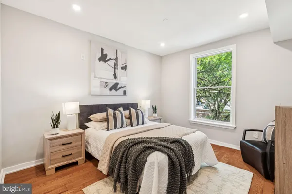 a bedroom with a bed and wooden floor