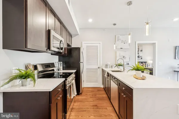 a kitchen with a sink stove and refrigerator
