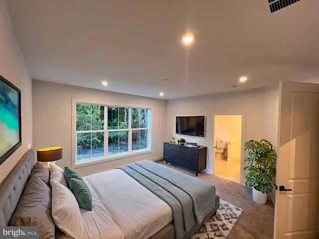 a bedroom with a bed and a television