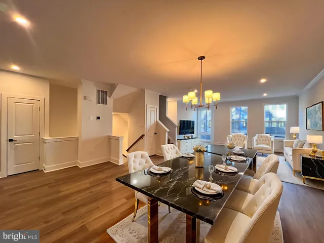 a living room with furniture a chandelier and wooden floor