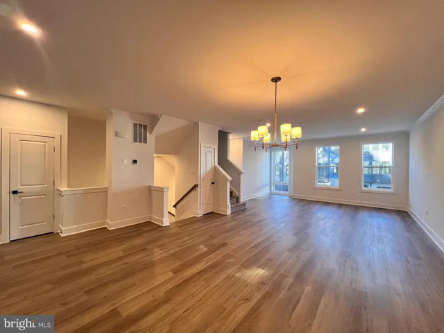 a view of a room with wooden floor and window