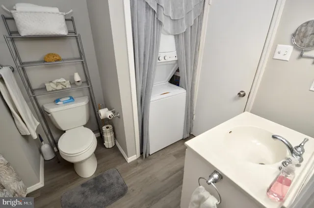 a white toilet sitting next to a bathroom sink