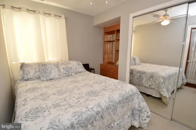 a bedroom with a bed and a mirror