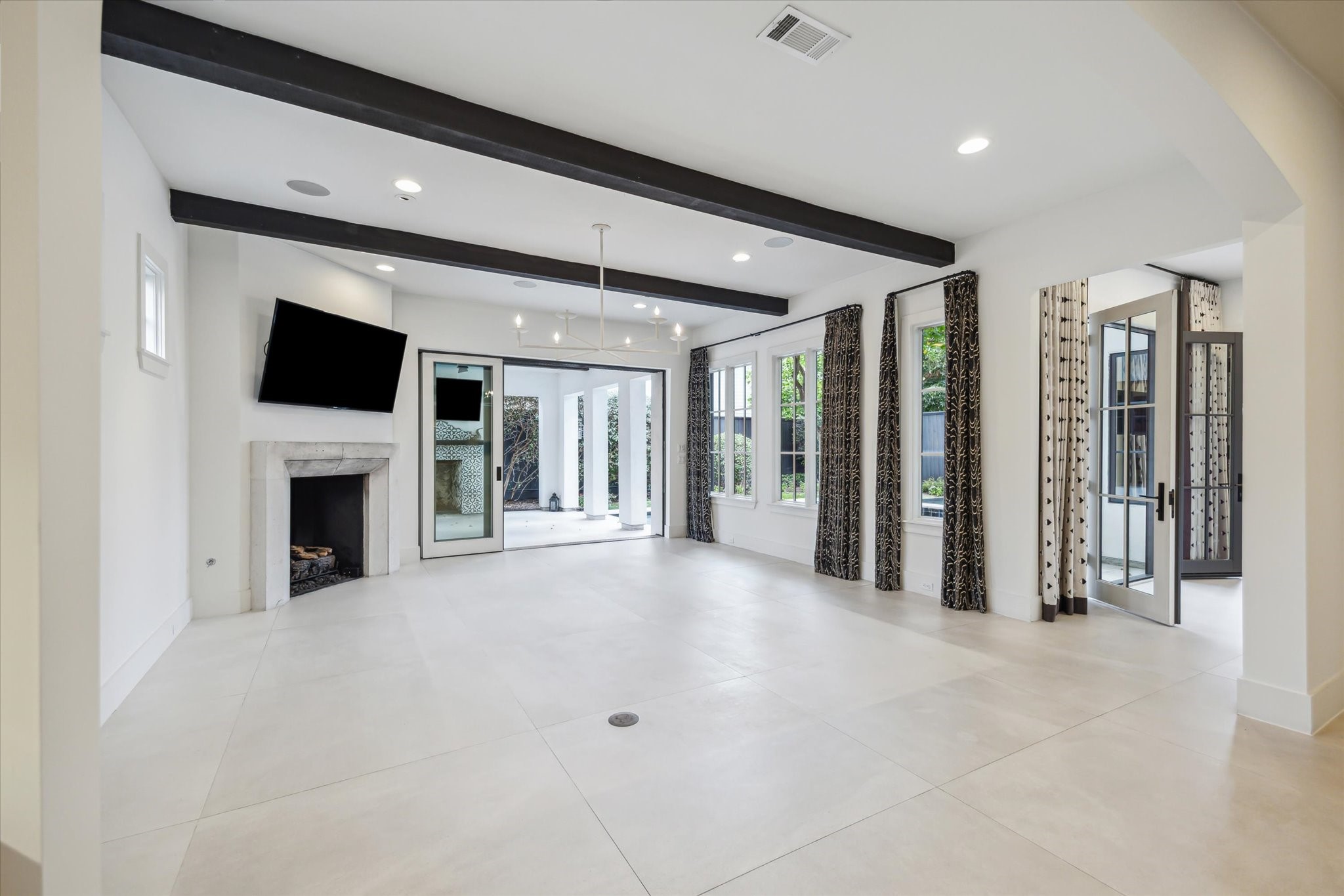 3214 Westheimer Road Houston, TX 77098 - Photo 13 of 39 Cozy up by the stunning gas log fireplace, which serves as the focal point of the family room’s warm and sophisticated design. The perfect blend of charm and functionality ensures it’s a space to enjoy year-round.